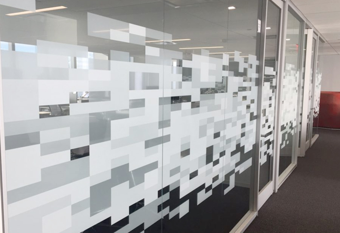 A large window wall with an abstract frosted pattern.