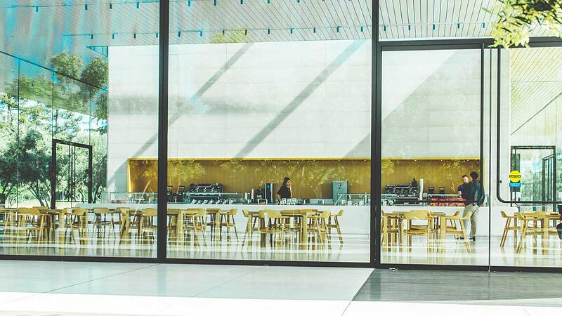 exterior of cafeteria with large floor-to-ceilling windows